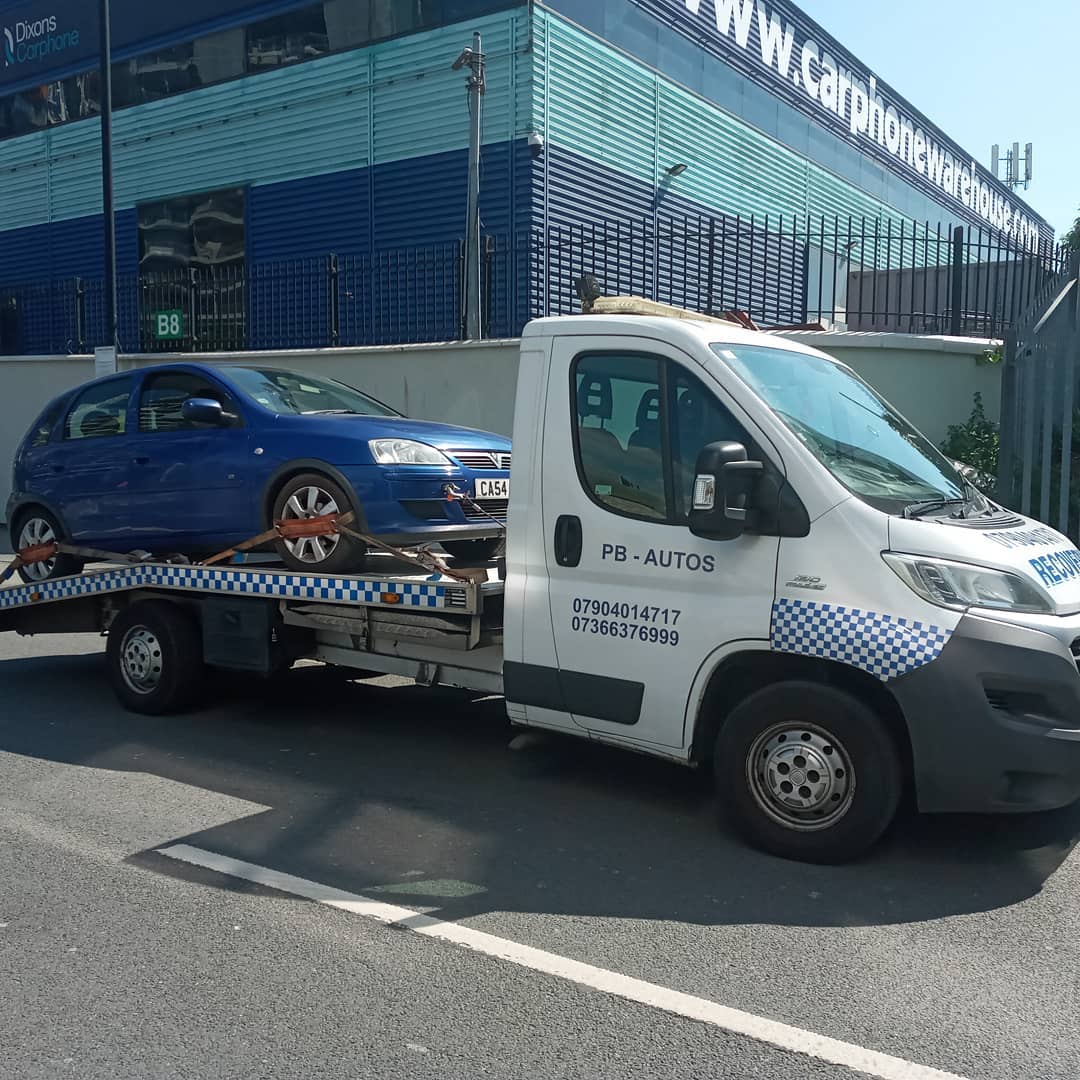 PB Autos recovery truck loading a car in London