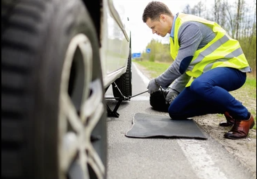 Technician performing roadside tyre change